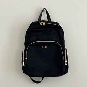 Calvin Klein Pre-Owned Black Canvas Back Pack with Gold coloured zippers.